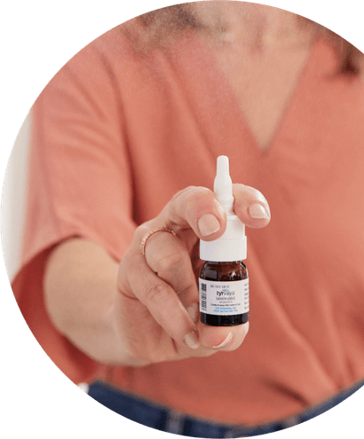Image of person holding a 4.2 mL bottle of Tyrvaya® (varenicline solution) nasal spray